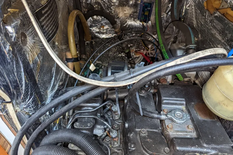 Slide: The Image of Engine compartment of a 1993 J Boats J/130 sailboat, showing mechanical components and wiring. - 40