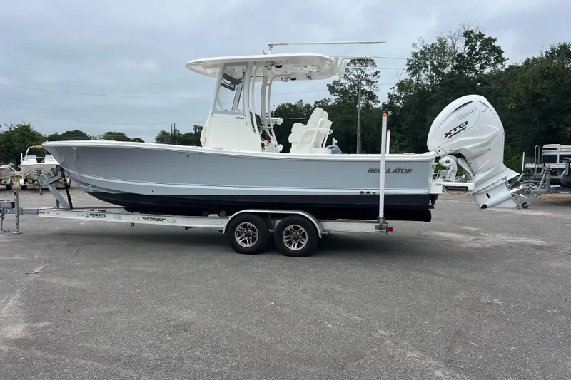 The Image of 2024 Regulator 26XO boat on trailer, side view, outdoors. - 1