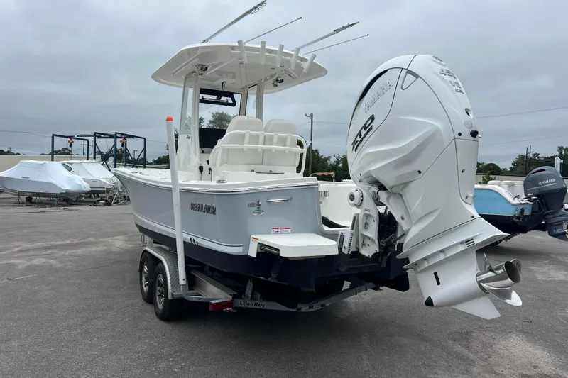 Slide: The Image of 2024 Regulator 26XO boat with Yamaha outboard engine on trailer. - 2