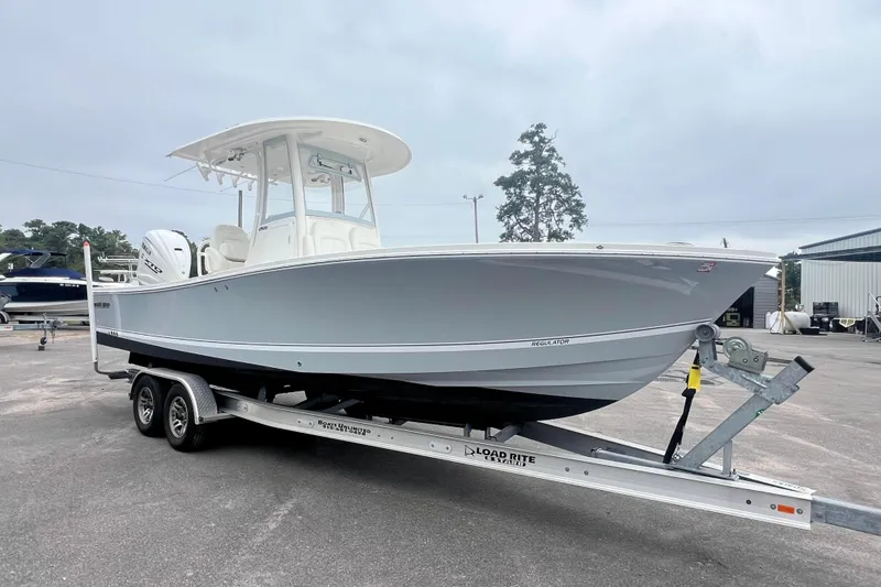 Slide: The Image of 2024 Regulator 26XO boat on trailer, displayed outdoors. - 5