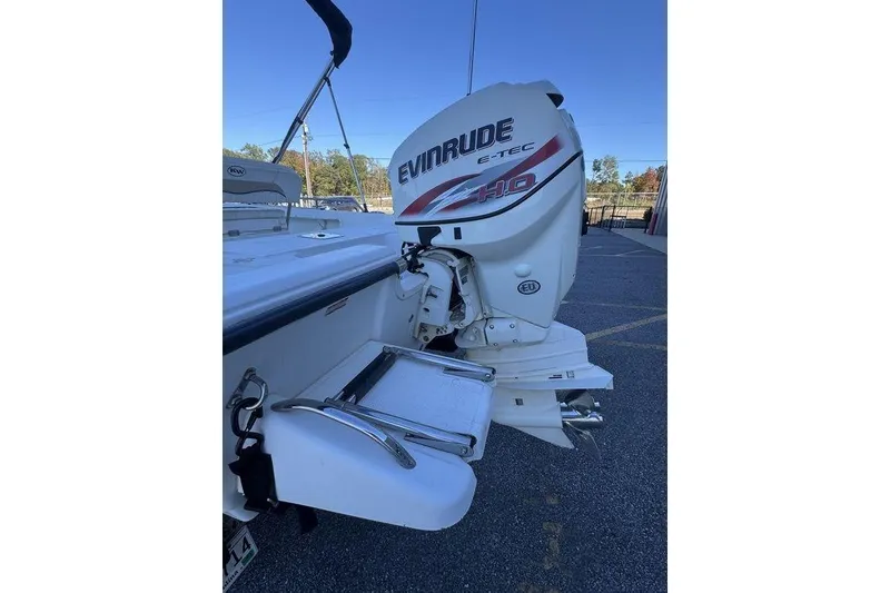 Slide: The Image of 2011 Key West 176 Bay Reef boat with Evinrude E-TEC engine, parked outdoors. - 13
