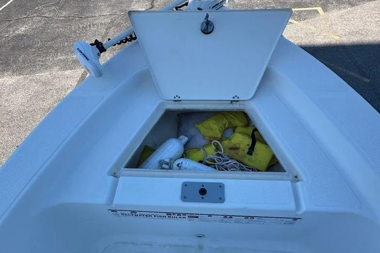 Slide: The Image of 2011 Key West 176 Bay Reef boat storage compartment with life jackets and rope. - 16