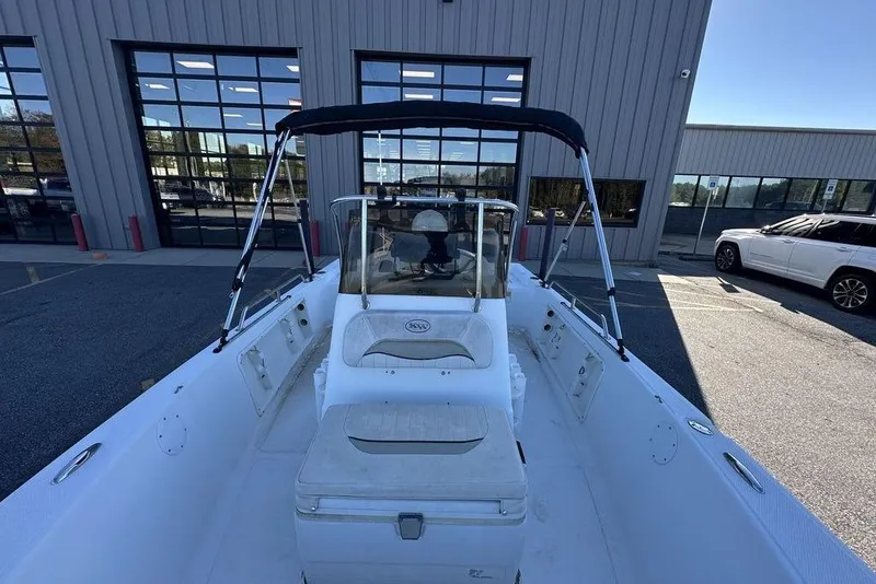 Slide: The Image of 2011 Key West 176 Bay Reef boat with bimini top, parked outside a building. - 18