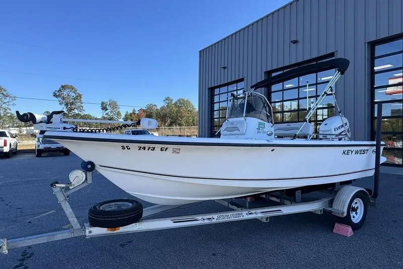 Slide: The Image of 2011 Key West 176 Bay Reef boat on trailer, parked outside a building. - 4