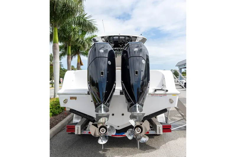 Slide: The Image of 2025 Sportsman Open 322 Center Console boat with dual outboard engines. - 15