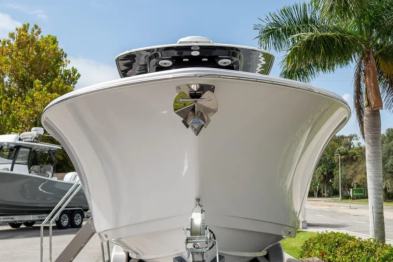 Slide: The Image of 2025 Sportsman Open 322 Center Console boat, front view, parked outdoors. - 20