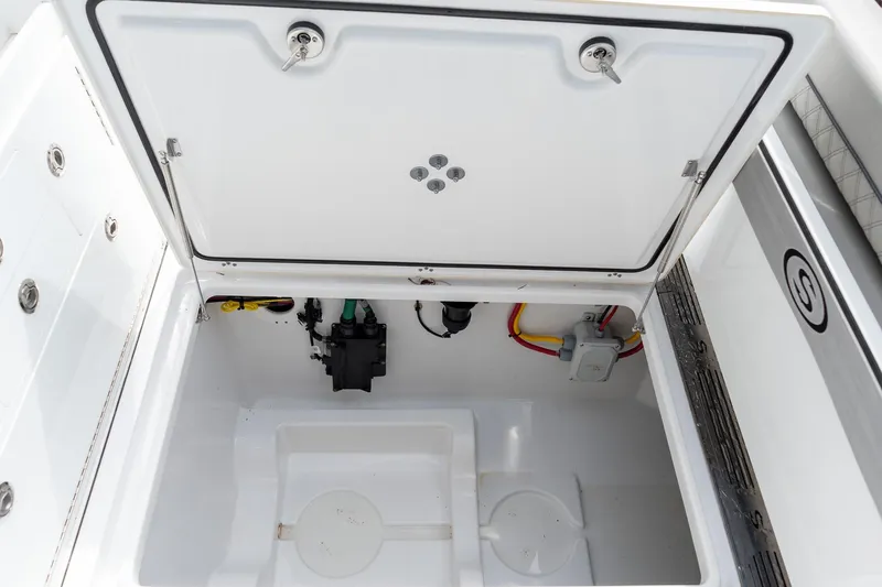Slide: The Image of 2025 Sportsman Open 322 Center Console storage compartment with open lid, showcasing interior details. - 26