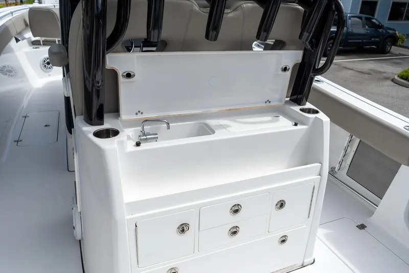 Slide: The Image of 2025 Sportsman Open 322 Center Console boat with sink and storage drawers. - 27