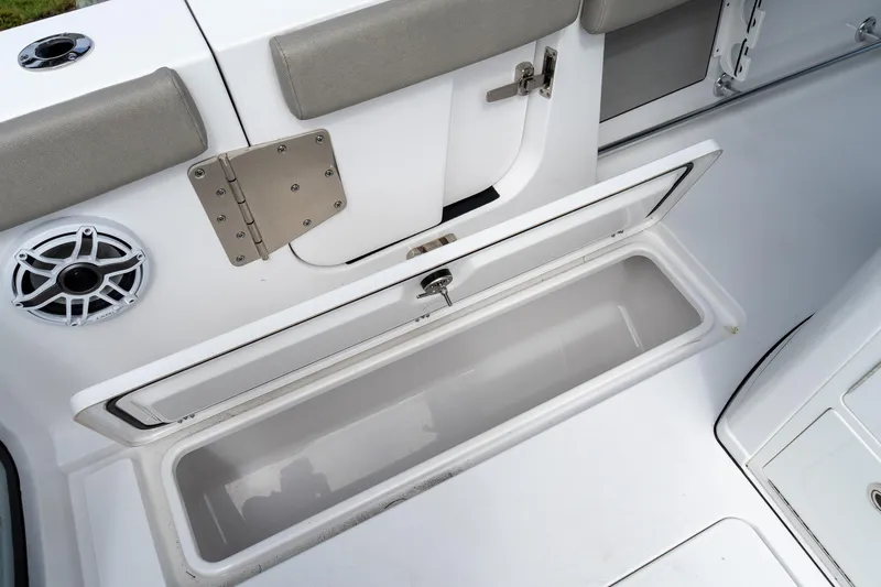 Slide: The Image of 2025 Sportsman Open 322 Center Console boat storage compartment and speaker detail. - 32