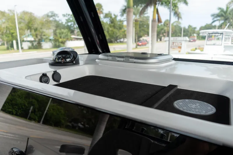 Slide: The Image of 2025 Sportsman Open 322 Center Console dashboard with compass and controls. - 36