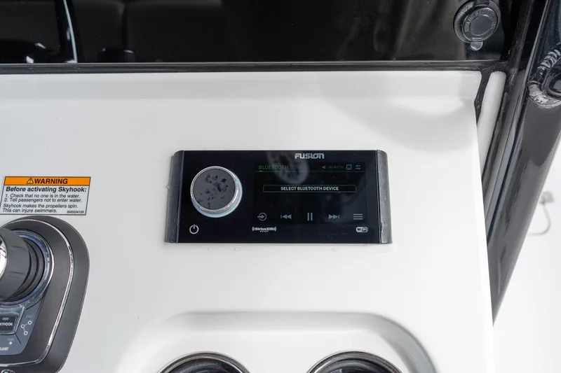 Slide: The Image of 2025 Sportsman Open 322 Center Console audio control panel with Bluetooth connectivity. - 38