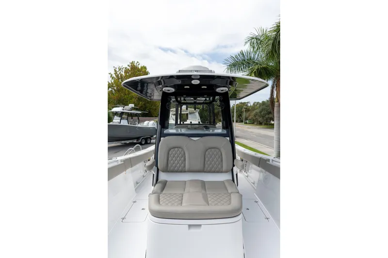Slide: The Image of 2025 Sportsman Open 322 Center Console boat with cushioned seating and sleek design. - 42