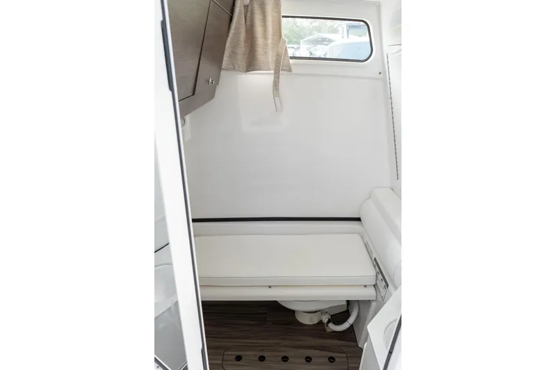 Slide: The Image of Interior of 2025 Sportsman Open 322 Center Console boat, featuring a compact cabin space. - 48