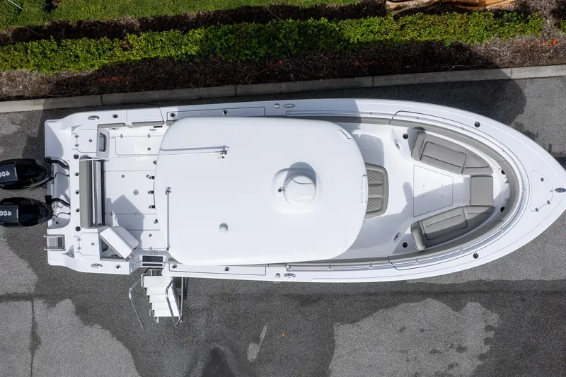 Slide: The Image of 2025 Sportsman Open 322 Center Console boat, aerial view, docked on pavement. - 5