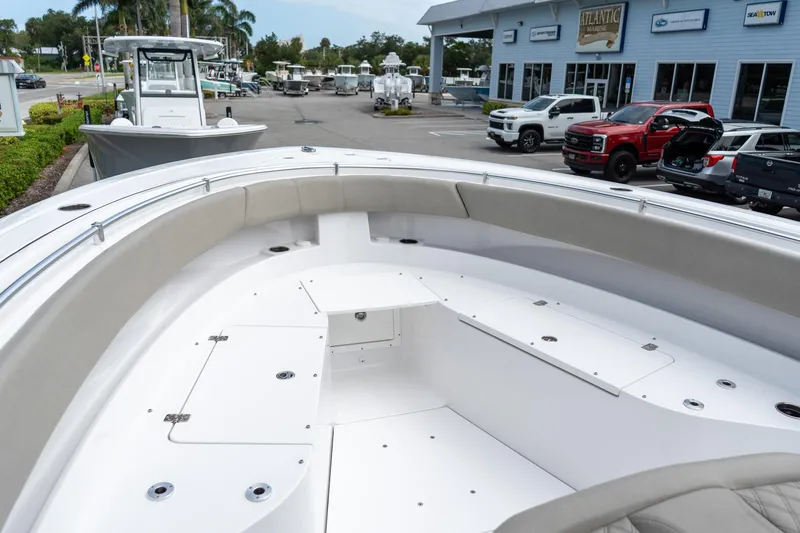 Slide: The Image of 2025 Sportsman Open 322 Center Console boat at dealership, showcasing spacious seating and storage. - 50