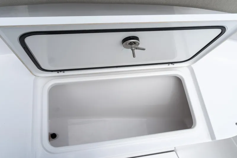 Slide: The Image of Open storage compartment on 2025 Sportsman Open 322 Center Console boat. - 52