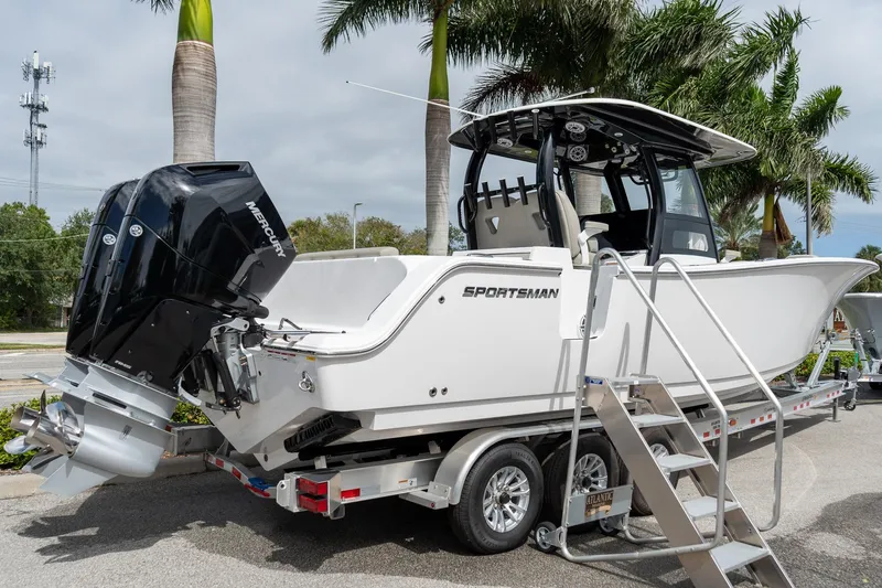 Slide: The Image of 2025 Sportsman Open 322 Center Console boat on trailer with dual Mercury engines. - 7