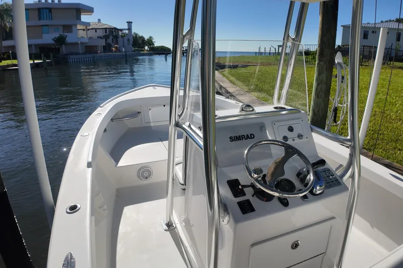 Slide: The Image of 2016 Albury Brothers 23 boat with Simrad navigation, docked by waterfront homes. - 10