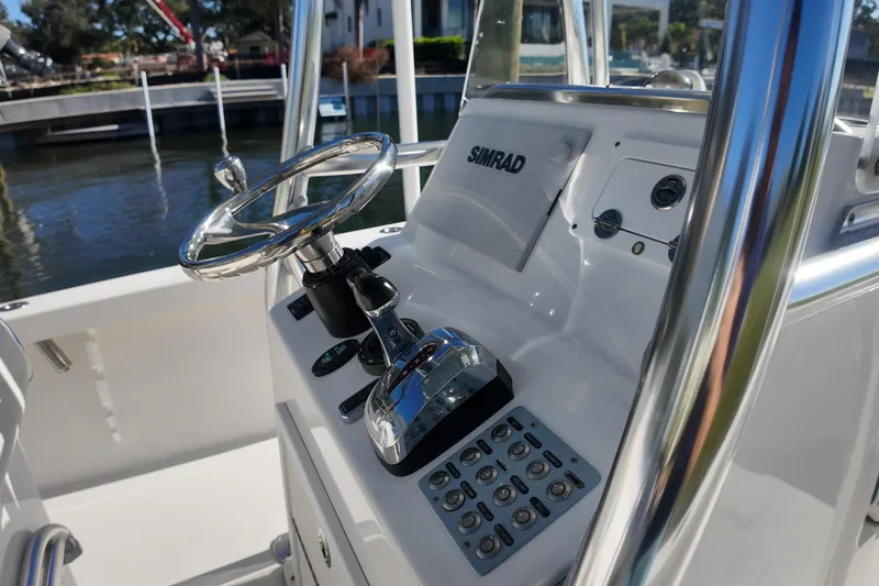 Slide: The Image of 2016 Albury Brothers 23 boat console with steering wheel and Simrad navigation system. - 12
