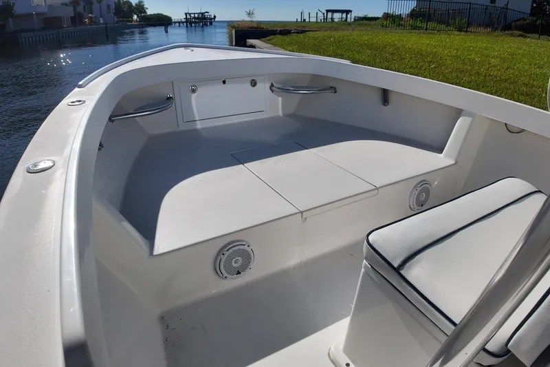 Slide: The Image of 2016 Albury Brothers 23 boat interior with seating and storage, near waterfront. - 14