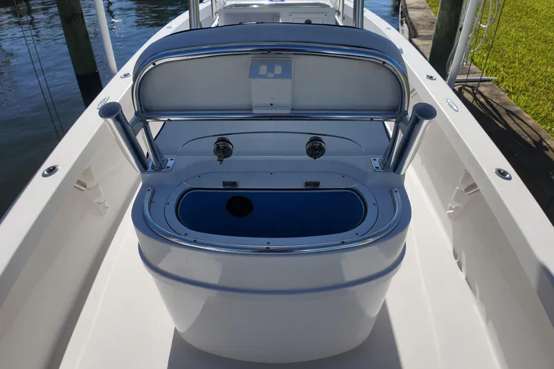 Slide: The Image of 2016 Albury Brothers 23 boat interior with open storage compartment and rod holders. - 16
