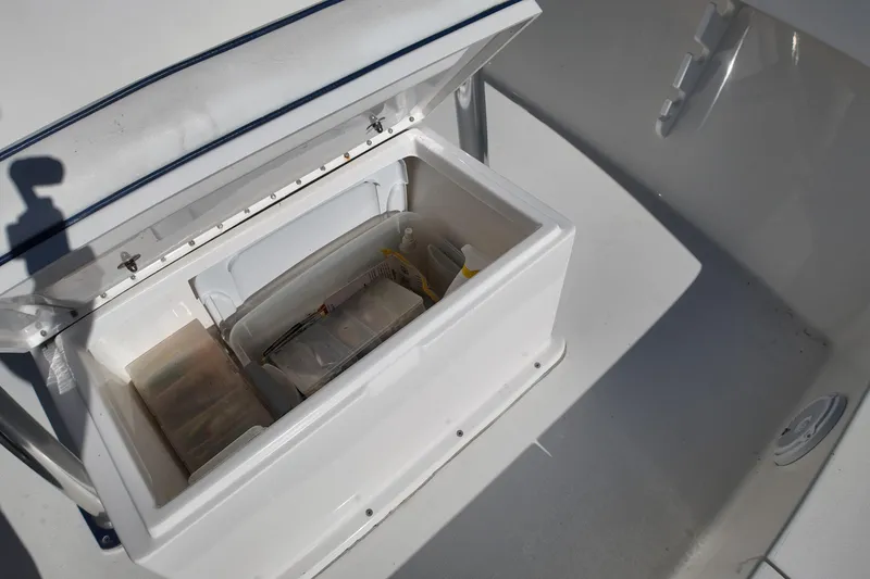 Slide: The Image of Open storage compartment on 2016 Albury Brothers 23 boat, containing organized gear and supplies. - 19