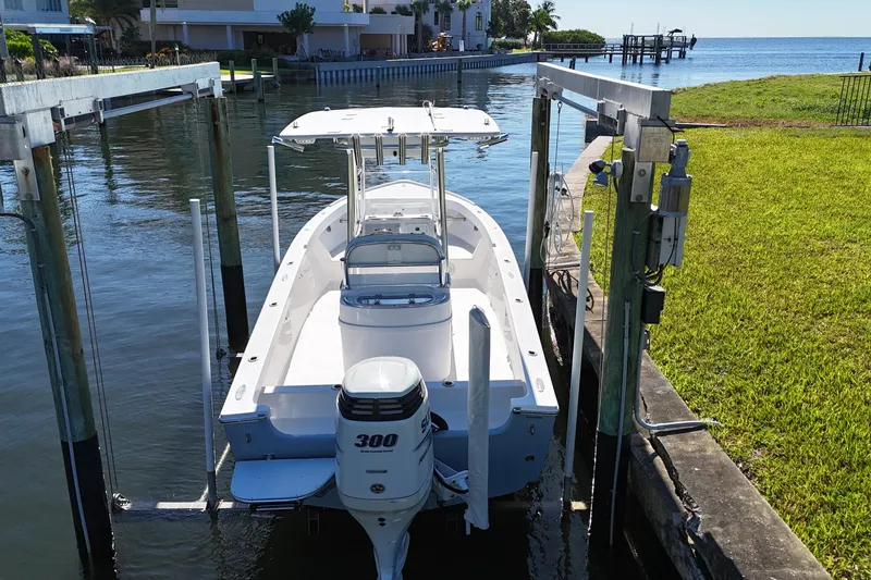 Slide: The Image of 2016 Albury Brothers 23 boat on lift by waterfront property. - 22