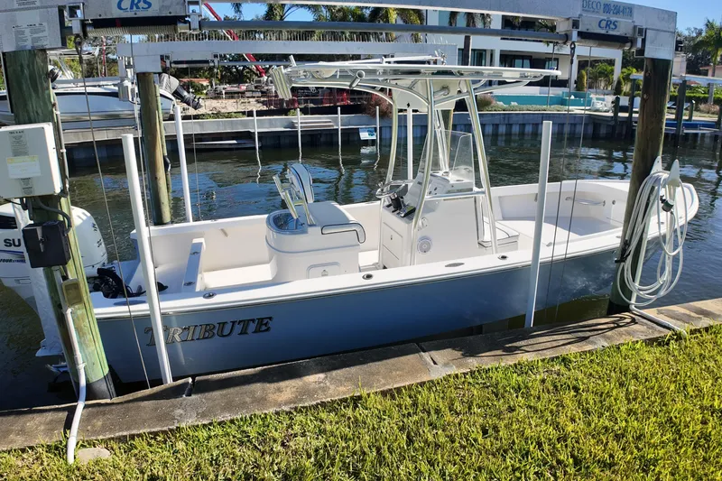 Slide: The Image of 2016 Albury Brothers 23 boat docked on a lift by the water. - 23