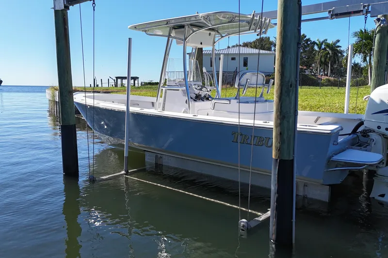 Slide: The Image of 2016 Albury Brothers 23 boat docked on a lift by the water. - 24