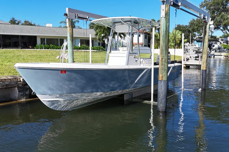 Slide: The Image of 2016 Albury Brothers 23 boat on lift, docked near waterfront property. - 3