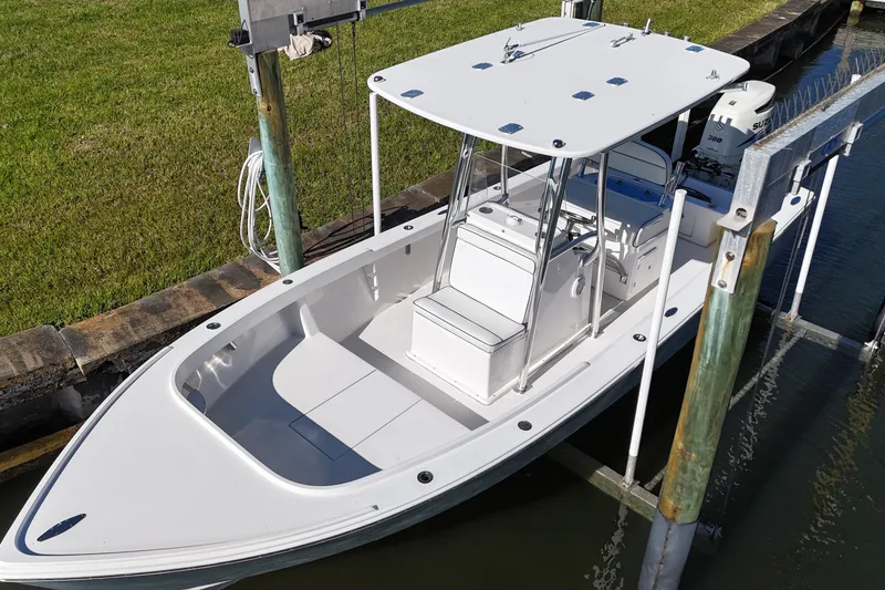 Slide: The Image of 2016 Albury Brothers 23 boat docked, featuring a sleek design and spacious deck. - 5