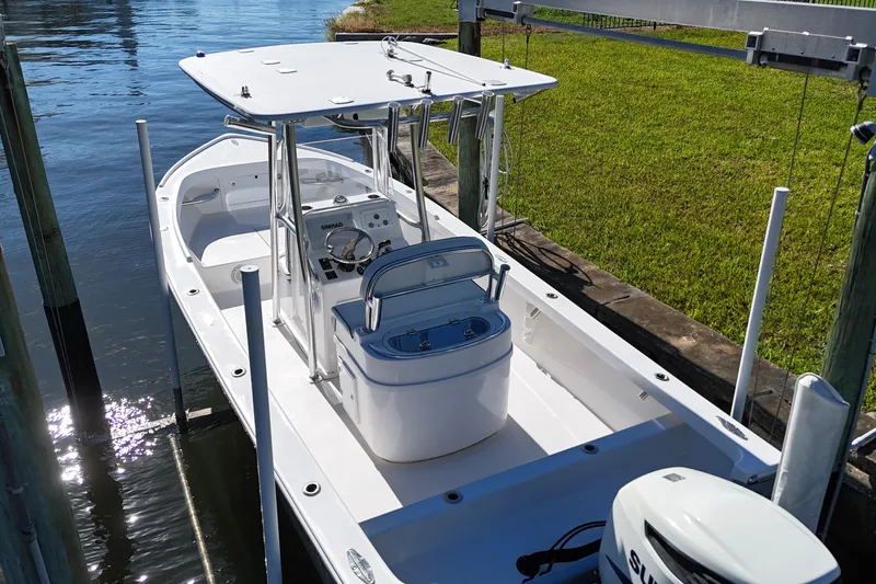 Slide: The Image of 2016 Albury Brothers 23 boat docked, featuring a center console and T-top. - 7