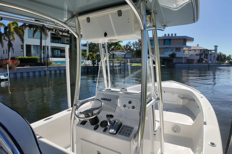 Slide: The Image of 2016 Albury Brothers 23 boat with console, docked near waterfront homes. - 9
