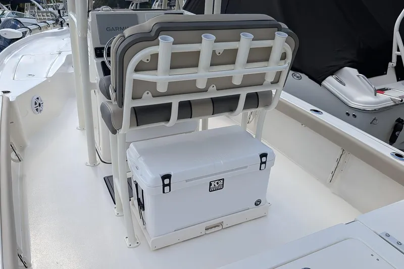 Slide: The Image of 2026 Key West 230 Bay Reef boat interior with cushioned seats and storage compartment. - 11
