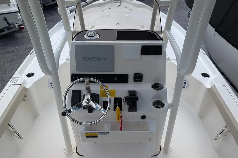 Slide: The Image of 2026 Key West 230 Bay Reef interior detail with rod holders and seating area. - 15