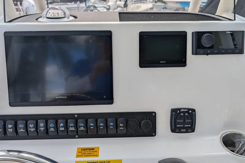 Slide: The Image of 2026 Key West 230 Bay Reef boat console with Garmin and Yamaha controls. - 16