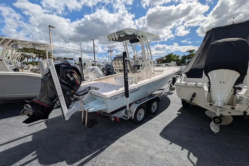 Slide: The Image of 2026 Key West 230 Bay Reef boat with Yamaha engine on trailer in marina. - 2