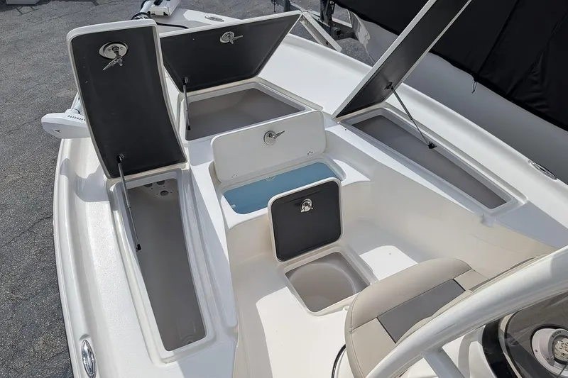 Slide: The Image of 2026 Key West 230 Bay Reef boat with open storage compartments and seating. - 20