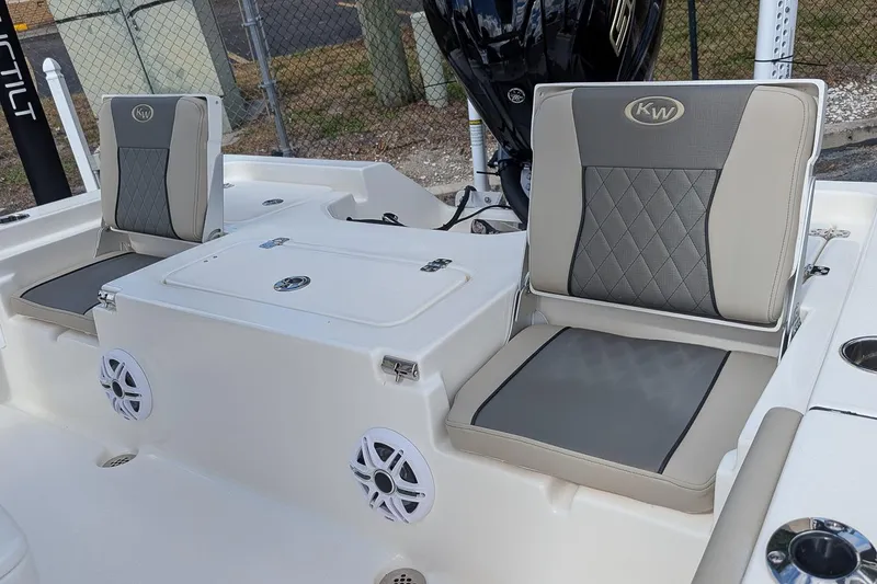 Slide: The Image of 2026 Key West 230 Bay Reef boat on trailer, featuring spacious deck and seating. - 9