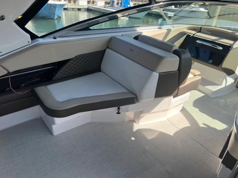 Slide: The Image of 2013 Regal 3200 Bowrider interior seating with luxurious upholstery and waterfront view. - 13