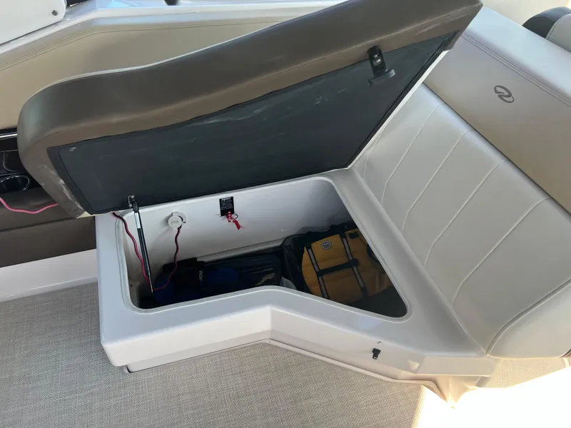 Slide: The Image of 2013 Regal 3200 Bowrider storage compartment with open seat lid. - 14