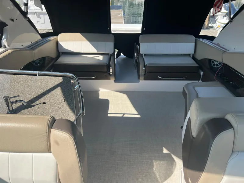 Slide: The Image of 2013 Regal 3200 Bowrider interior with beige and white seating. - 16