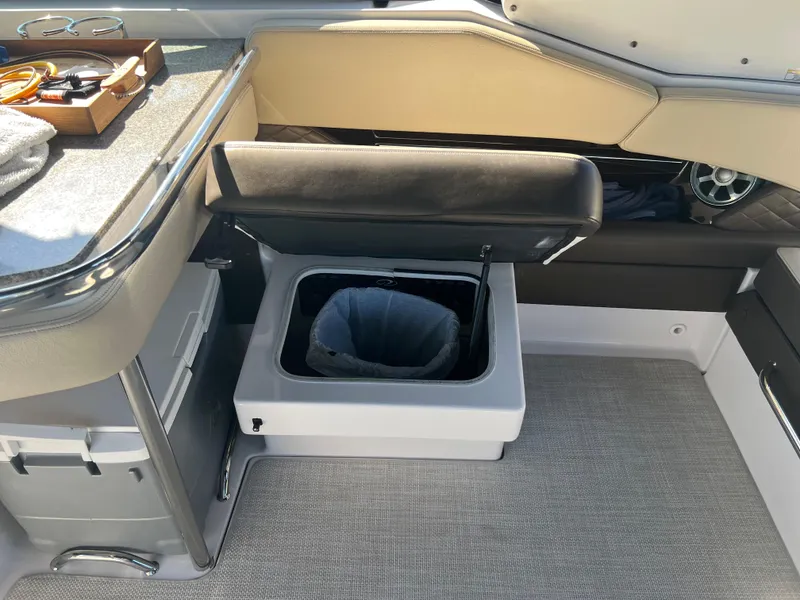 Slide: The Image of 2013 Regal 3200 Bowrider interior with built-in trash bin. - 18