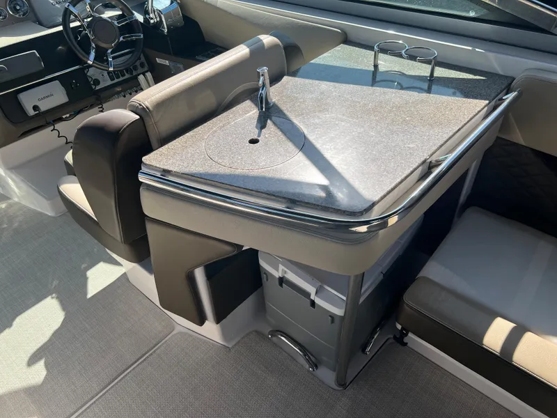 Slide: The Image of 2013 Regal 3200 Bowrider boat interior with sink and seating area. - 19