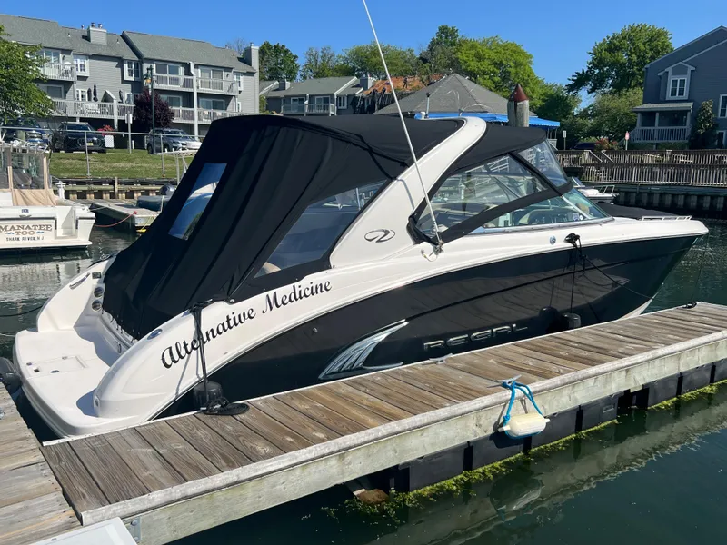 Slide: The Image of 2013 Regal 3200 Bowrider boat named Alternative Medicine docked at a marina. - 2