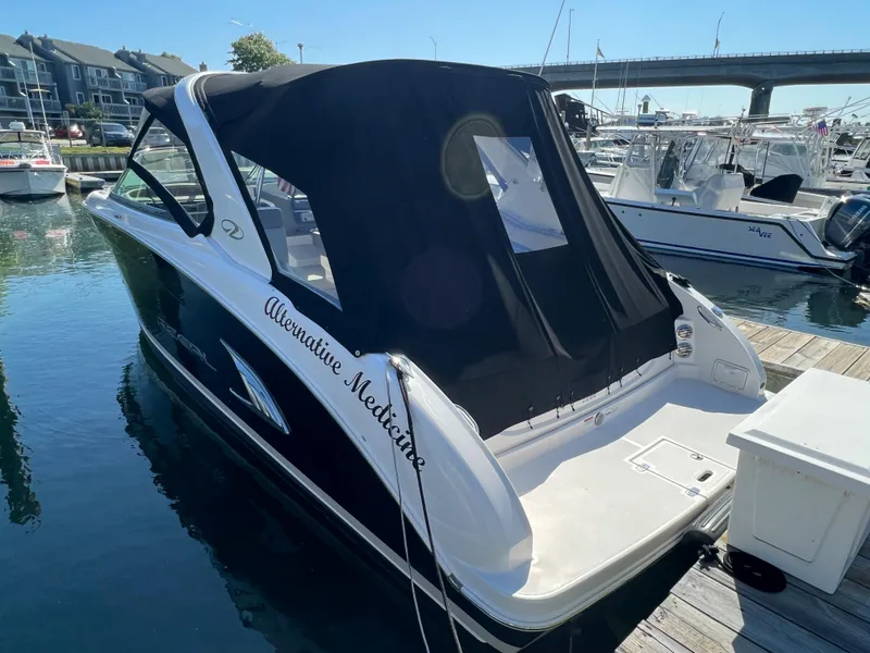 Slide: The Image of 2013 Regal 3200 Bowrider boat docked at a marina. - 4