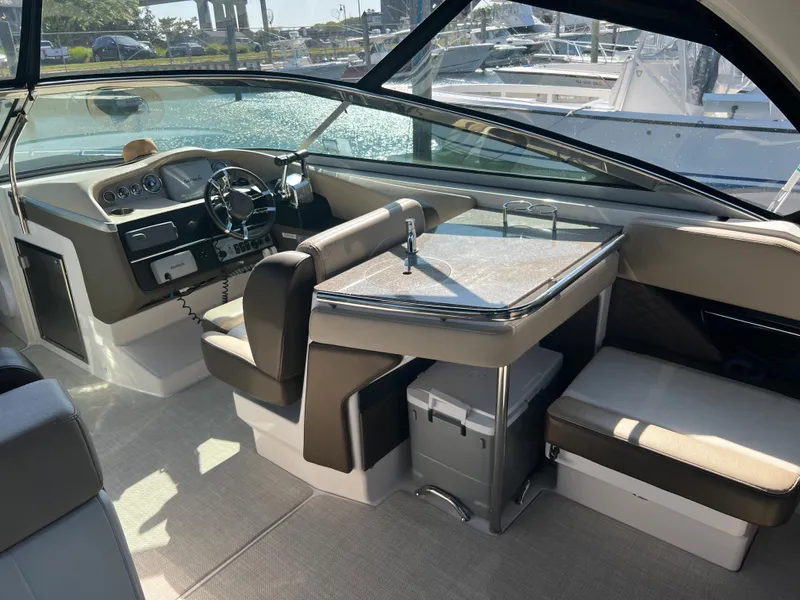 Slide: The Image of 2013 Regal 3200 Bowrider boat interior with seating and helm station. - 6