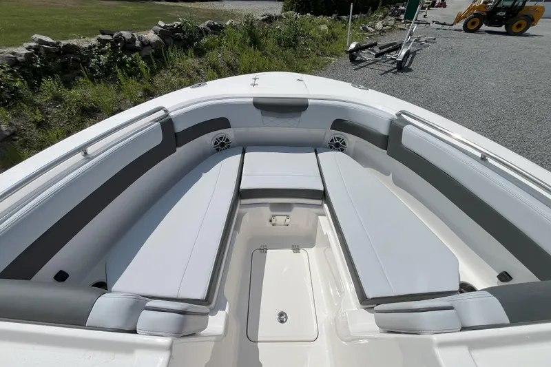 Slide: The Image of 2026 Robalo R257 Dual Console boat interior with cushioned seating and storage. - 15