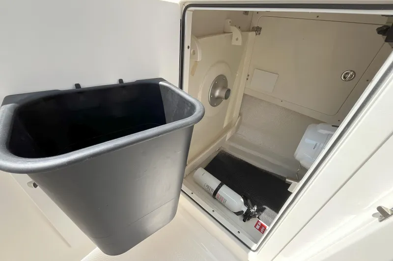 Slide: The Image of Interior storage compartment of 2026 Robalo R257 Dual Console boat. - 19