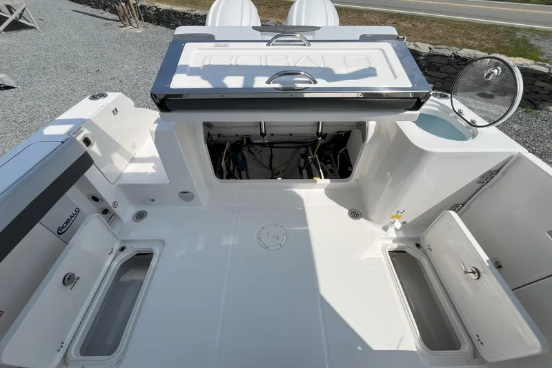 Slide: The Image of 2026 Robalo R257 Dual Console boat interior with open storage compartments and clean white deck. - 3